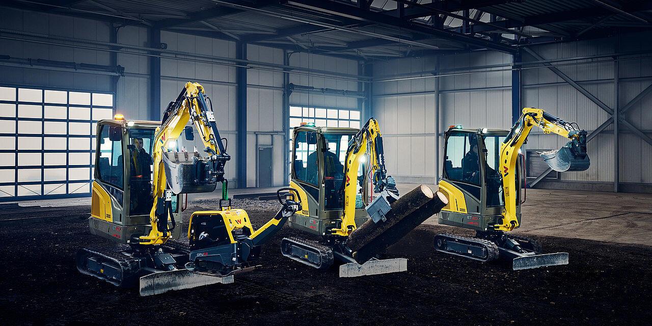 mini excavators in a row in industry hall