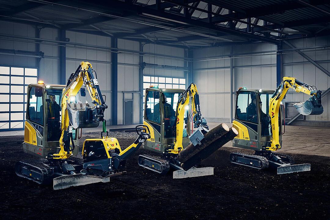 mini excavators in a row in industry hall