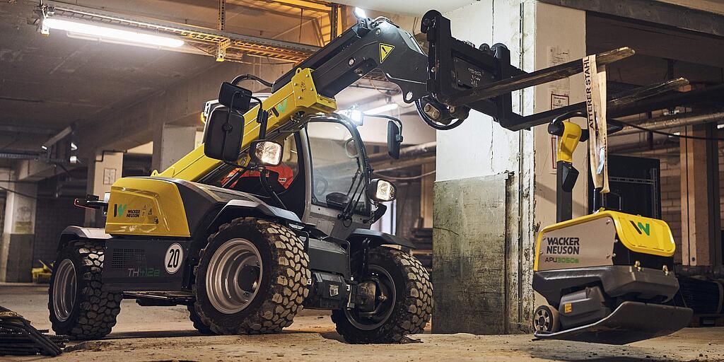 Electric telehandler with electric vibratory plate in action