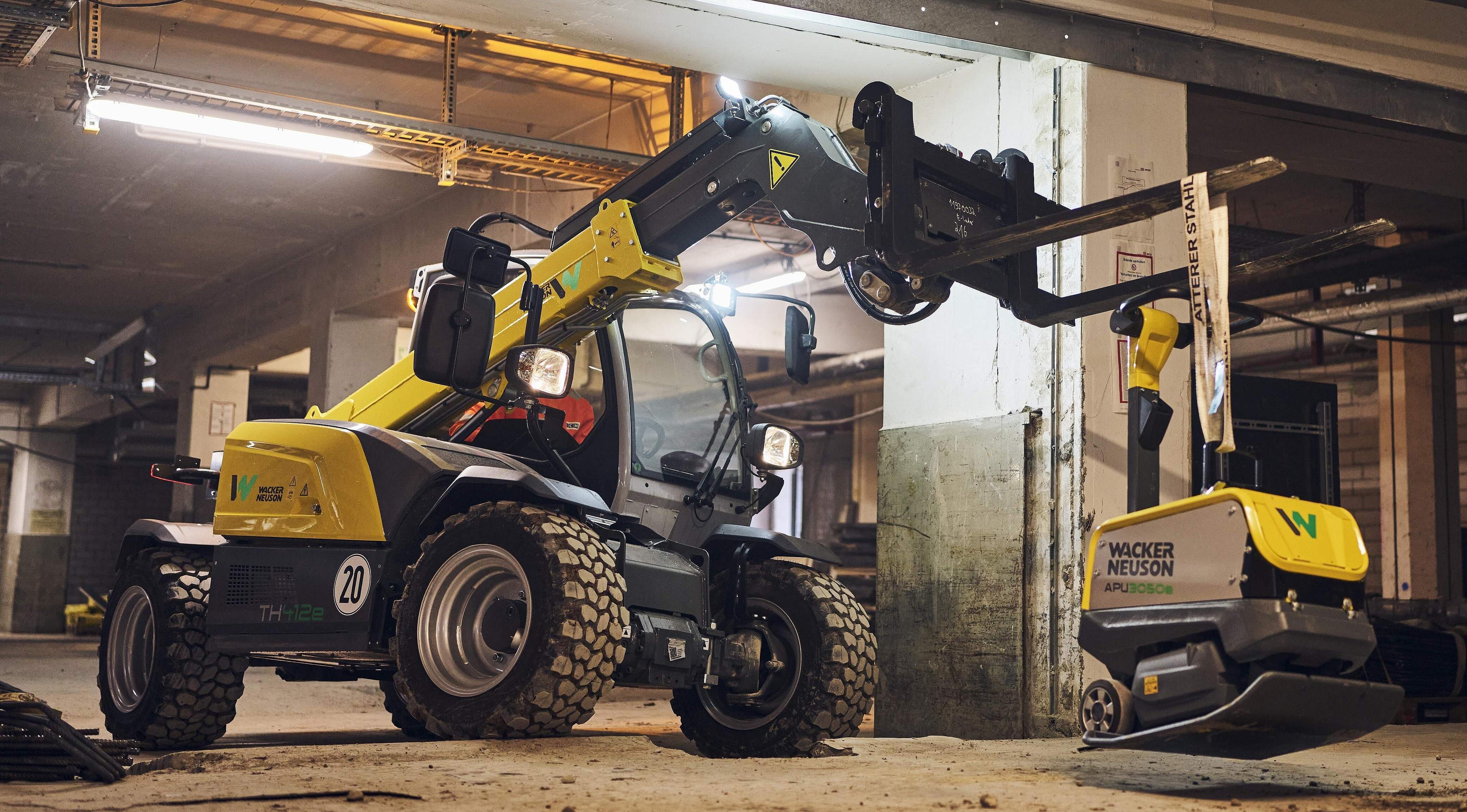 Electric telehandler with electric vibratory plate in action