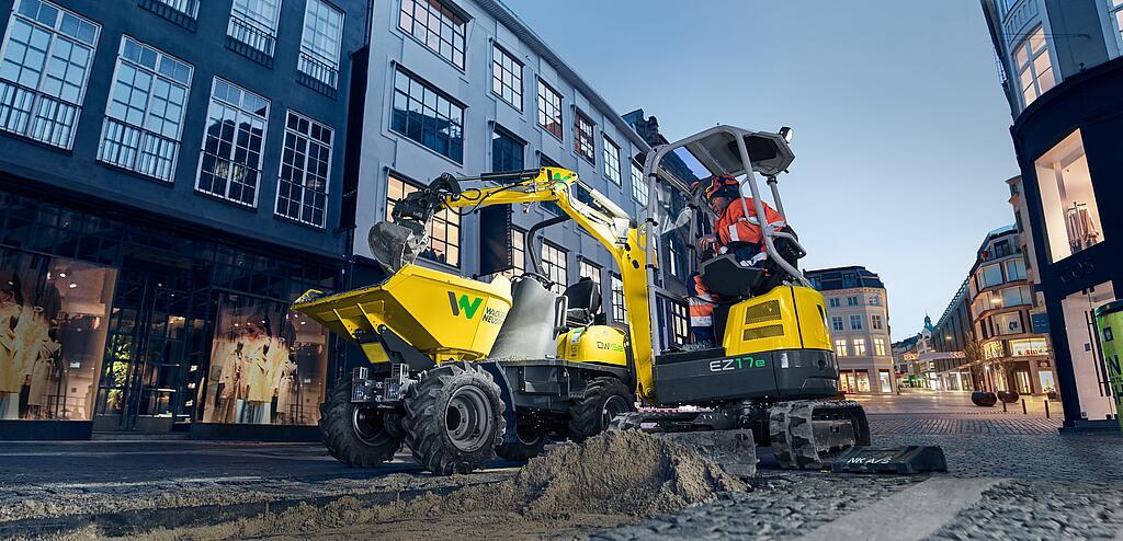 Экскаватор с нулевым выносом задней части EZ17e от компании Wacker Neuson во время работы на стройплощадке в городе.