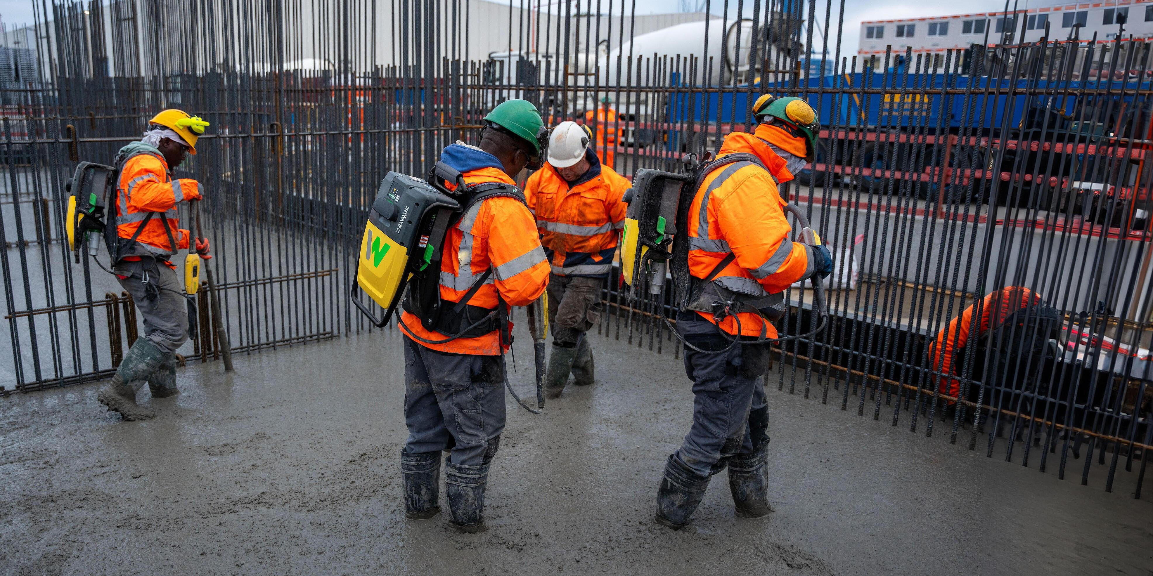 some workers consolidating concrete